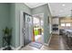 Inviting entryway with hardwood floors, open to a modern kitchen and a view of the charming front porch at 19959 Cowie Ln, Westfield, IN 46074