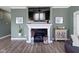 Living room fireplace with mantle decor, art, and hardwood floors at 19959 Cowie Ln, Westfield, IN 46074