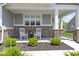 Inviting front porch features white rocking chairs, brick accents, and meticulous landscaping for a cozy curb appeal at 19959 Cowie Ln, Westfield, IN 46074