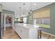 Spacious kitchen island with seating, modern pendant lighting, and open layout to the living area and pantry at 19959 Cowie Ln, Westfield, IN 46074