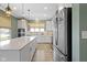 Bright kitchen features a large island, stainless steel appliances, white cabinets, and modern lighting at 19959 Cowie Ln, Westfield, IN 46074