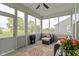 Relaxing screened porch with cozy seating, ceiling fan, and ample natural light, perfect for enjoying the outdoors at 19959 Cowie Ln, Westfield, IN 46074