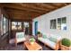 Inviting back porch with cozy furniture, plants and overhead wood planks on the ceiling at 2001 S Jefferson St, Muncie, IN 47302