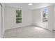 Bright bedroom featuring neutral carpet and paint plus two bright windows at 2001 S Jefferson St, Muncie, IN 47302