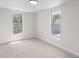 Bright bedroom featuring neutral carpet and paint plus two bright windows at 2001 S Jefferson St, Muncie, IN 47302