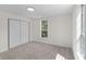 Bedroom featuring neutral carpet, paint, a closet, and a bright window at 2001 S Jefferson St, Muncie, IN 47302