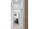 Hallway with neutral carpet and paint leading to a bright bathroom at 2001 S Jefferson St, Muncie, IN 47302