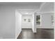 Hallway with dark floors, white walls, and natural light at 2001 S Jefferson St, Muncie, IN 47302
