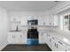 Bright kitchen with stainless steel appliances, white cabinets, and modern countertops at 2001 S Jefferson St, Muncie, IN 47302