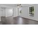 Bright living room features sleek flooring, fresh paint, and natural light from the windows at 2001 S Jefferson St, Muncie, IN 47302