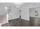 Open-concept living room with hardwood floors, staircase, modern lighting and neutral decor at 2001 S Jefferson St, Muncie, IN 47302