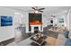 Bright living room featuring a modern fireplace, sleek dark floors and an open layout to the dining area at 2001 S Jefferson St, Muncie, IN 47302