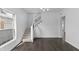 Bright, open living room with hardwood floors, a staircase, and large windows for natural light at 2001 S Jefferson St, Muncie, IN 47302