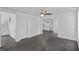 Open-concept living room with new floors, fresh paint, and stairs nearby at 2001 S Jefferson St, Muncie, IN 47302