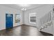 Bright living room with hardwood floors, staircase, chandelier, and lots of natural light at 2001 S Jefferson St, Muncie, IN 47302