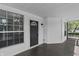 Inviting covered front porch with classic columns, wood flooring, and a charming entrance door at 2001 S Jefferson St, Muncie, IN 47302