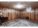 Unfinished basement space with wood paneling, a window, and concrete floors at 2020 Rosedale Dr, Indianapolis, IN 46227