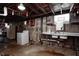 This unfinished basement area features a sink, washer, dryer hookups, exposed beams, and room for customization at 2020 Rosedale Dr, Indianapolis, IN 46227