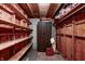 Unfinished basement storage with wooden shelving and a metal cabinet at 2020 Rosedale Dr, Indianapolis, IN 46227