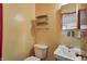 Small bathroom with peach walls, wall shelves, and vintage sink at 2020 Rosedale Dr, Indianapolis, IN 46227