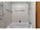 Clean bathroom with a white tub and tiled walls at 2020 Rosedale Dr, Indianapolis, IN 46227