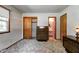Well-lit bedroom featuring closet, adjacent bathroom, and vintage-style carpet at 2020 Rosedale Dr, Indianapolis, IN 46227