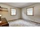 Cozy bedroom with two windows providing natural light and vintage-style carpet at 2020 Rosedale Dr, Indianapolis, IN 46227