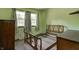 Charming bedroom with natural light, neutral carpet, and classic wooden furniture at 2020 Rosedale Dr, Indianapolis, IN 46227