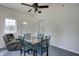 Bright dining area features many windows, modern ceiling fan and a comfortable chair at 2020 Rosedale Dr, Indianapolis, IN 46227