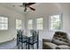 Bright dining area features many windows, modern ceiling fan and a comfortable chair at 2020 Rosedale Dr, Indianapolis, IN 46227