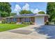 Charming brick home with solar panels, attached garage, and a well-manicured front lawn at 2020 Rosedale Dr, Indianapolis, IN 46227