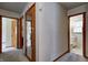 Hallway with wood doors and neutral colored walls leading to bathroom and bedroom at 2020 Rosedale Dr, Indianapolis, IN 46227