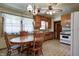 Traditional kitchen with wooden cabinets, laminate flooring, and adjacent dining area at 2020 Rosedale Dr, Indianapolis, IN 46227