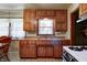 Vintage kitchen featuring wood cabinets and a functional layout with essential appliances at 2020 Rosedale Dr, Indianapolis, IN 46227