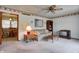 Cozy living room featuring a ceiling fan and vintage decor with access to the dining area at 2020 Rosedale Dr, Indianapolis, IN 46227