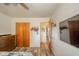 A view of the bedroom featuring a closet, dresser, wood floors, and a mounted TV, providing comfort and functionality at 2113 W Barcelona Dr, Muncie, IN 47304