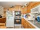 Kitchen showcases traditional wood cabinets, stainless steel microwave and stove at 2113 W Barcelona Dr, Muncie, IN 47304