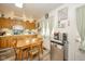 Traditional kitchen with wood cabinets, a breakfast table with chairs, and stainless steel mini fridge at 2113 W Barcelona Dr, Muncie, IN 47304