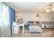 Bright living room features a comfortable gray sofa, a desk area, and hardwood floors at 2113 W Barcelona Dr, Muncie, IN 47304