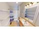 Bright bathroom featuring a vanity, mirror, shower, toilet and shelving at 2259 Colfax Ln # 2259, Indianapolis, IN 46260