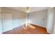 This is a spacious bedroom with hardwood floors and a ceiling fan at 2259 Colfax Ln # 2259, Indianapolis, IN 46260
