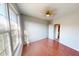 Well-lit bedroom with hardwood floors, featuring a ceiling fan, large window, and neutral paint at 2259 Colfax Ln # 2259, Indianapolis, IN 46260