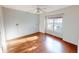 Bright bedroom featuring a ceiling fan, large window, natural light, and hardwood floors at 2259 Colfax Ln # 2259, Indianapolis, IN 46260