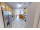 Well-lit kitchen featuring stainless steel appliances and a large island with tile flooring throughout at 2259 Colfax Ln # 2259, Indianapolis, IN 46260