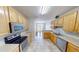 Bright kitchen featuring light wood cabinetry, stainless steel appliances, and tile flooring at 2259 Colfax Ln # 2259, Indianapolis, IN 46260