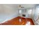 Bright living room featuring hardwood floors, a fireplace, and large windows at 2259 Colfax Ln # 2259, Indianapolis, IN 46260