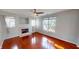 Cozy living room showcasing hardwood floors, a fireplace, and modern ceiling fan at 2259 Colfax Ln # 2259, Indianapolis, IN 46260