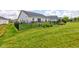 Landscaped backyard with a black fence, lush green grass and flower beds at 2500 Sand Hollow Dr, Lebanon, IN 46052