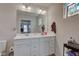 This bathroom features a double sink vanity and decorative stained glass window at 2500 Sand Hollow Dr, Lebanon, IN 46052