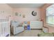 This bedroom features a dresser, side chair, and a crib at 2500 Sand Hollow Dr, Lebanon, IN 46052
